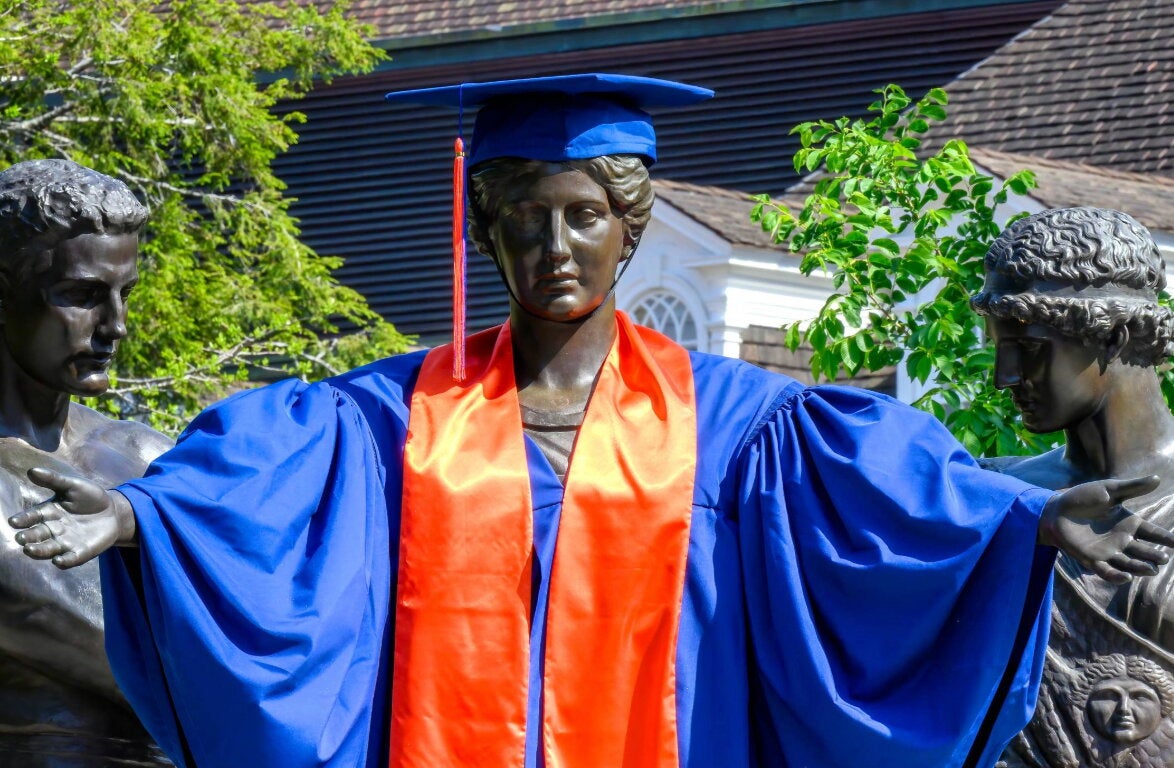 Alma Mater in a cap and gown.