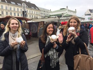 Students eating Krapfen at Naschmarkt February 2017