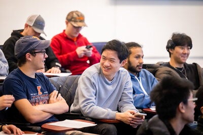 Students smile and chat before class starts.