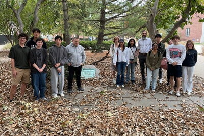 The David Kinley Grave Walkers stop for a photo in front of a stone marking Gregory's grave.
