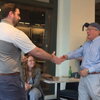 Morris Kleiner shakes hands with a presenter as he accepts his lifetime achievement award.