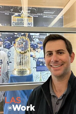 Matthew Doppelt is pictured with the 2020 LA Dodgers World Series trophy.