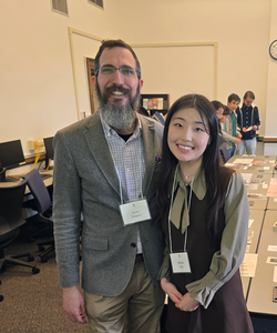 Professor DiIanni and Shinbi pose in front of a large table full of David Kinley artifacts.