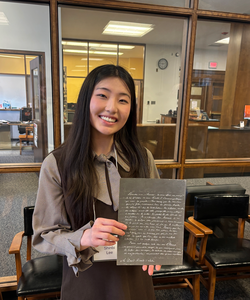 Shinbi Lee poses with her favorite piece from the archives.