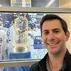 Matthew Doppelt is pictured with the 2020 LA Dodgers World Series trophy.